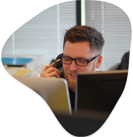 Man on phone looking at computer